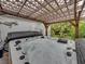 Luxurious hot tub with a lattice-covered pergola and lush tropical landscaping at 6202 7Th S Ave, Gulfport, FL 33707