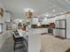 Spacious kitchen featuring an island with marble countertops, stainless steel appliances, white cabinetry, and tiled floors at 6202 7Th S Ave, Gulfport, FL 33707