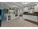 Bright kitchen boasts white cabinetry, tiled floors, an island, modern appliances, and plenty of natural light at 6202 7Th S Ave, Gulfport, FL 33707