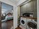 Convenient laundry area with modern appliances and built-in storage solutions, adjacent to a bedroom at 6202 7Th S Ave, Gulfport, FL 33707