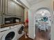 Well-organized laundry room with modern washer and dryer, built-in cabinetry, and wood floors at 6202 7Th S Ave, Gulfport, FL 33707