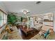 Open-concept living room with a view of the kitchen, featuring comfortable seating and hardwood floors at 6202 7Th S Ave, Gulfport, FL 33707