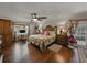 Comfortable bedroom with wood floors, a ceiling fan, ample natural light and views of the yard at 6202 7Th S Ave, Gulfport, FL 33707