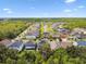 Gorgeous aerial view of a suburban neighborhood featuring lush greenery and a scenic pond at 6214 Windship Ct, Tampa, FL 33647