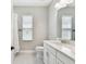 Bright bathroom features a single vanity with stone countertop, mirror, and tile floors at 6214 Windship Ct, Tampa, FL 33647