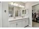 Bright bathroom features a double vanity, large mirror, and walk-in closet for ample storage at 6214 Windship Ct, Tampa, FL 33647