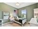 Neutral bedroom featuring a ceiling fan, window, bed, and white furniture set at 6214 Windship Ct, Tampa, FL 33647