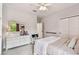 Neutral bedroom featuring a ceiling fan, bed, and a dresser at 6214 Windship Ct, Tampa, FL 33647