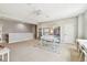 Large bonus room with neutral decor, built-in shelving, and a comfortable seating area at 6214 Windship Ct, Tampa, FL 33647