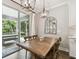 Dining area with a large wooden table, chairs and sliding glass doors to screened in patio at 6214 Windship Ct, Tampa, FL 33647