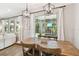 Dining area with a large wooden table and chairs with a view of the backyard at 6214 Windship Ct, Tampa, FL 33647