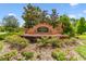 Community entrance featuring a brick sign and landscaped greenery at 6214 Windship Ct, Tampa, FL 33647