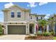 Charming two-story home featuring a gray facade, landscaped yard, and an attached two-car garage at 6214 Windship Ct, Tampa, FL 33647