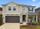 Two-story home boasts a two-car garage, charming front porch and manicured landscaping at 6214 Windship Ct, Tampa, FL 33647