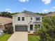 Two-story home with a gray exterior and inviting front lawn at 6214 Windship Ct, Tampa, FL 33647