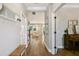 Charming hallway with decorative accents, wooden floors, and views into the living room with neutral decor at 6214 Windship Ct, Tampa, FL 33647