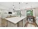 Kitchen and dining area with quartz counters, an island, and modern stainless steel appliances at 6214 Windship Ct, Tampa, FL 33647