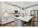 Kitchen featuring granite countertops, stainless steel appliances, and an island with bar seating at 6214 Windship Ct, Tampa, FL 33647