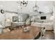 Open-concept living and dining area with hardwood floors, white cabinetry, and modern lighting fixtures at 6214 Windship Ct, Tampa, FL 33647