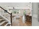 Bright living room with hardwood floors, large windows, and seamless flow to the open kitchen and dining area at 6214 Windship Ct, Tampa, FL 33647