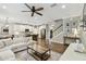 Expansive living space with a kitchen island, white cabinetry, and an open flow perfect for entertaining at 6214 Windship Ct, Tampa, FL 33647