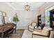 Cozy living space with comfortable armchairs, elegant light fixture, and refined decor at 6214 Windship Ct, Tampa, FL 33647