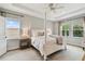 Bright bedroom with a four poster bed, tray ceiling, and large windows providing natural light at 6214 Windship Ct, Tampa, FL 33647