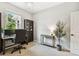 Bright home office featuring a large window, modern chandelier, and comfortable workspace at 6214 Windship Ct, Tampa, FL 33647