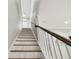 Interior shot of the home's staircase with wood railing and white risers at 6214 Windship Ct, Tampa, FL 33647