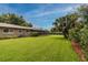 Spacious backyard featuring well-maintained lawn, mature trees, and manicured shrubbery, creating a serene outdoor oasis at 6635 9Th N Ave, St Petersburg, FL 33710