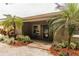 Inviting front entrance featuring palm trees and a cozy front porch, enhancing curb appeal at 6635 9Th N Ave, St Petersburg, FL 33710