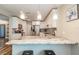 Bright kitchen featuring white cabinetry, stainless steel appliances, and a stylish marble countertop breakfast bar at 6635 9Th N Ave, St Petersburg, FL 33710