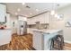 Bright kitchen with white cabinets, stainless steel appliances, and a breakfast bar with barstools at 6635 9Th N Ave, St Petersburg, FL 33710