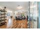 Bright living room featuring hardwood floors, a comfortable sectional sofa, and a glimpse into the dining area at 6635 9Th N Ave, St Petersburg, FL 33710