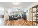 Open-concept living room with hardwood floors, a large sectional sofa, and views of the dining area at 6635 9Th N Ave, St Petersburg, FL 33710