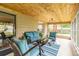 Relaxing sunroom featuring wood ceilings, comfortable seating, and natural light, creating an inviting indoor-outdoor space at 6635 9Th N Ave, St Petersburg, FL 33710