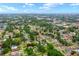 Discover an aerial view of the property set amongst a lush neighborhood of mature trees at 6807 N Himes Ave, Tampa, FL 33614
