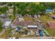 This aerial view showcases the backyard, featuring sheds, a tent, and ample parking at 6807 N Himes Ave, Tampa, FL 33614