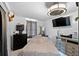 Simple bedroom with a bed, dresser, TV, and a ceiling fan, offering a basic living space at 6807 N Himes Ave, Tampa, FL 33614
