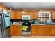Functional kitchen featuring wood cabinets, stainless steel appliances, and practical layout at 6807 N Himes Ave, Tampa, FL 33614