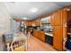 Eat-in kitchen with warm wood cabinets, stainless steel appliances, and tile flooring at 6807 N Himes Ave, Tampa, FL 33614