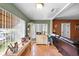 Bright living room with large windows providing ample natural light, wood-look floors and neutral colored walls at 6807 N Himes Ave, Tampa, FL 33614