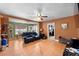 Inviting living room with tile flooring, ceiling fan, and comfortable seating area with a plush black leather sofa at 6807 N Himes Ave, Tampa, FL 33614