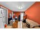 Bright living room featuring tile flooring, a sofa, a mini fridge, and access to the backyard at 6807 N Himes Ave, Tampa, FL 33614