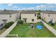 This aerial photograph shows a private backyard with a garden, grill, small pool, and a white fence on a grassy lawn at 6961 King Creek Dr, Sun City Center, FL 33573