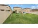 Backyard with green grass, a swing, and a white vinyl fence at 6961 King Creek Dr, Sun City Center, FL 33573