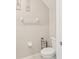 A neutral-toned powder room features a toilet and convenient storage rack at 6961 King Creek Dr, Sun City Center, FL 33573