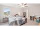 This bright bedroom features a ceiling fan, a side table and a large window at 6961 King Creek Dr, Sun City Center, FL 33573