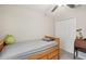 A well-lit bedroom includes a ceiling fan, wood bed, and closet at 6961 King Creek Dr, Sun City Center, FL 33573