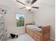 Bedroom featuring a wooden bed, carpeted floors, ceiling fan, and lots of natural light at 6961 King Creek Dr, Sun City Center, FL 33573